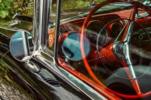 Close-up of a vintage Chevrolet's steering wheel with a classic design.